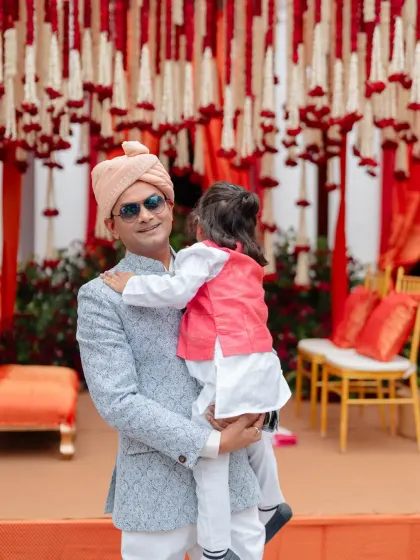 We craft decor that serves as a beautiful backdrop for the couple's story. Here, Surbhi and Virat share a quiet moment against the rich red and white floral decor of their wedding day.