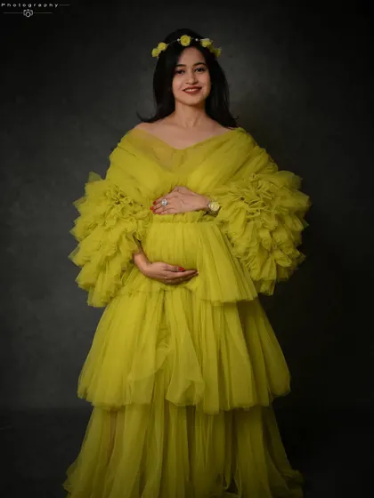 A bright and happy portrait in a vibrant lime-green tulle gown. The floral headband adds a sweet, bohemian touch.