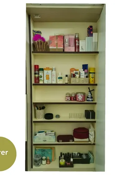 A tall, narrow cabinet in the dressing room, transformed from a cluttered space to a beautifully organized storage area for cosmetics, skincare, and documents.