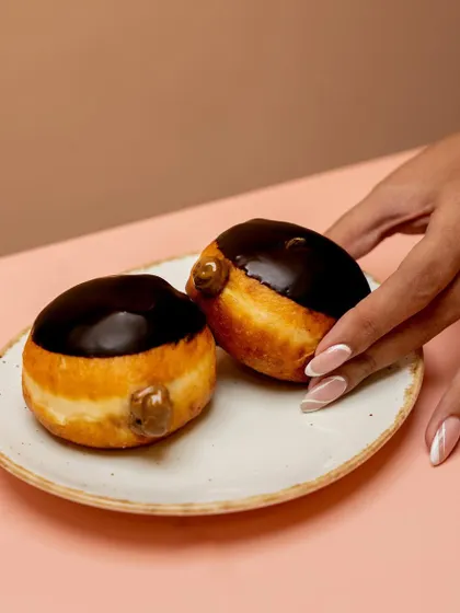Two of our classic Chocolate Berliners, glazed and ready to go. A simple, satisfying treat for any time of day.