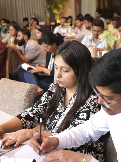 Team members taking notes, fully absorbed in the AI workshop.