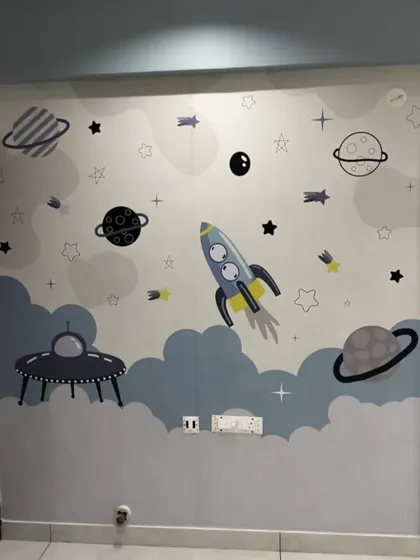 A fun outer space themed wallpaper with rockets, planets, and UFOs, perfect for a future astronaut's bedroom.