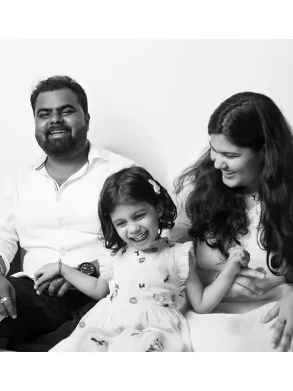 A candid black and white shot of a family sharing a laugh. These are the spontaneous moments that truly define a family's love.