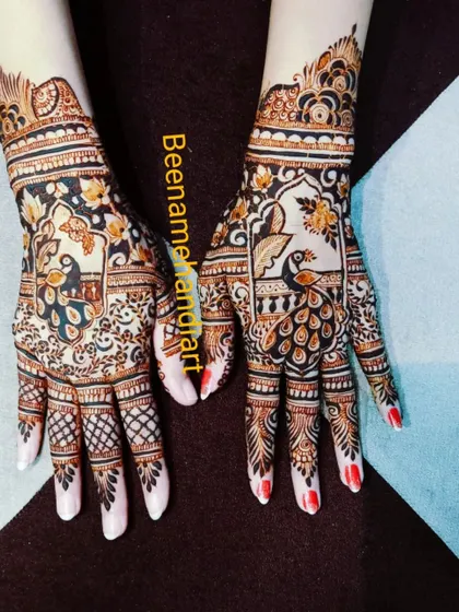 A beautiful design featuring peacocks in a garden-like setting. The red nail polish provides a lovely contrast to the dark henna.
