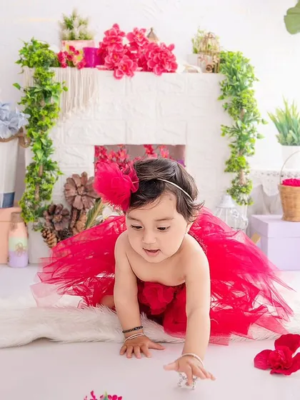 On the move. This crawling shot captures the exploratory nature of a baby girl in a beautiful red tutu.