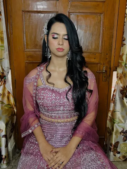 The client seated, showing the full effect of her party-ready look.