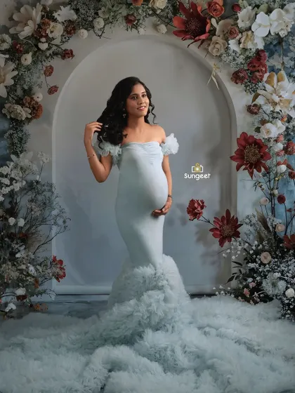 A slightly different angle of the floral arch setup, capturing a candid, happy expression.