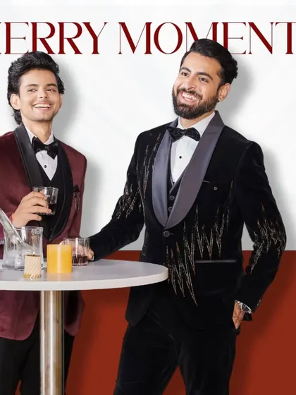 Merry moments in our finest tuxedos. This image captures the celebratory spirit in our embellished black and classic maroon velvet tuxedos.