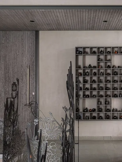 This image shows the 'Kalrav Seasons' railing in context with other interior elements, including a custom shelving unit, illustrating how our art can complement various design styles.
