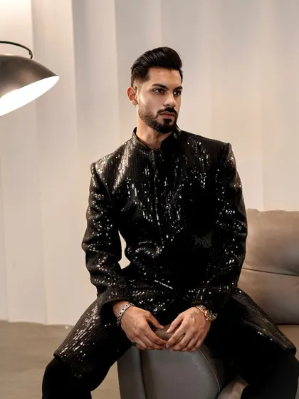 The light catches the sequins on this jacket, creating a starry night effect. This is the perfect outfit for a man who isn't afraid to stand out.