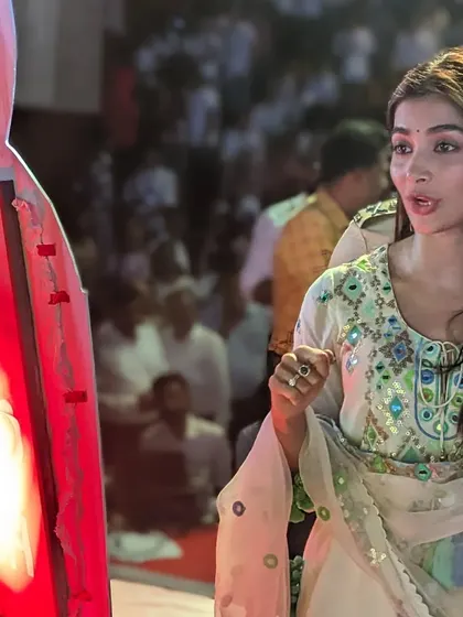 Actress Pooja Hegde taking a closer look at the sand art lightbox after the show.