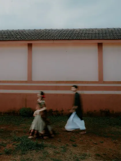 A motion-blur shot of a couple walking at a heritage site, creating an artistic and ethereal feel.