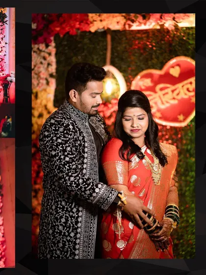 The couple poses in front of their reception stage decor. The heart-shaped sign with their names adds a personal touch to their celebration.