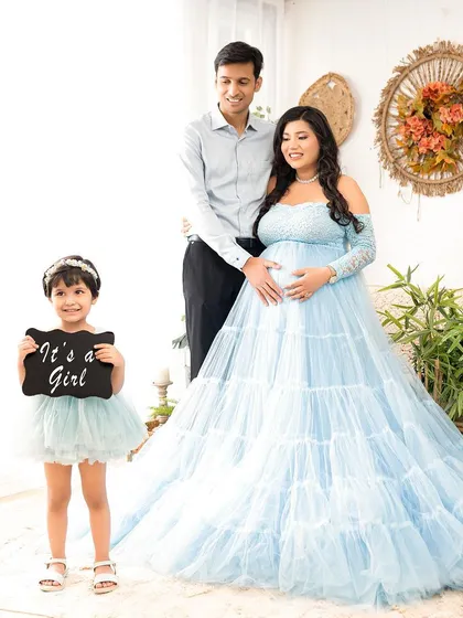 "It's a girl!" A creative way to announce the gender of your new baby, with the older sibling holding a cute sign.