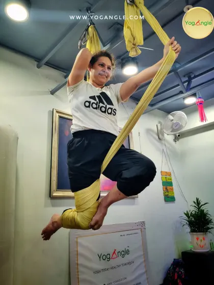 There is a real sense of freedom and play in aerial yoga. This dynamic pose combines strength and balance, showing how the practice can be both a workout and a joyful expression of movement.