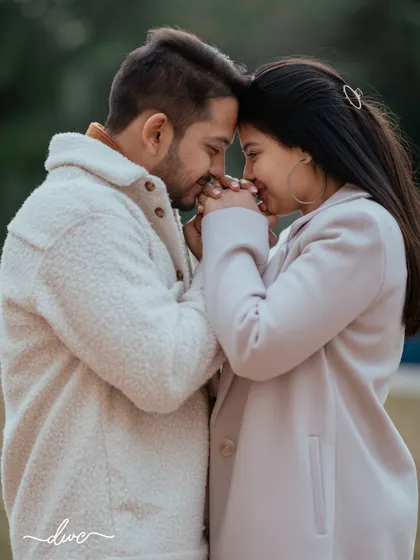 A sweet and gentle pre-wedding moment, with the couple holding hands, their heads together in a gesture of love and comfort.