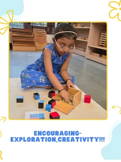 A girl works with the binomial cube, a sensorial material that introduces algebraic concepts in a concrete way. This hands-on approach lays a strong foundation for future mathematical understanding.