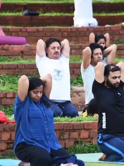 Participants practice a seated yoga posture, focusing on spinal alignment and breath. Even simple seated exercises, when done with awareness, can have a profound effect on one's energy and state of mind.