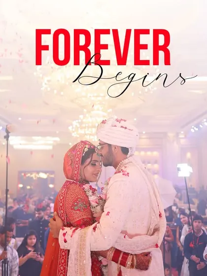 A romantic shot of the groom kissing his bride's forehead, with the words 'Forever Begins' encapsulating the promise of the day.