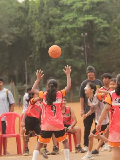 A jump ball in the girls' U-11 game. The focus and determination on their faces say it all.
