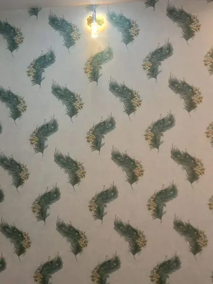 A wall with a repeating peacock feather pattern, adding a touch of exotic beauty and color.