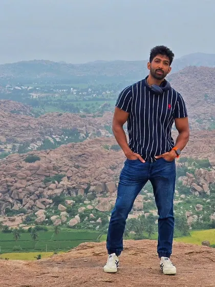 The view from Anjanadri Hill in Hampi, believed to be the birthplace of Lord Hanuman. The landscape of paddy fields and boulders is breathtaking.