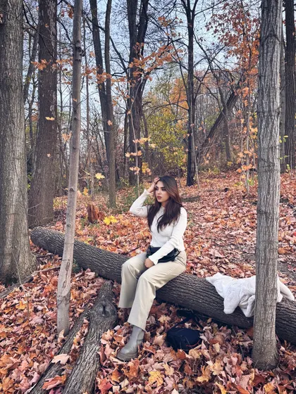 Sitting on a log in a forest at Blue Mountain, surrounded by a carpet of autumn leaves.