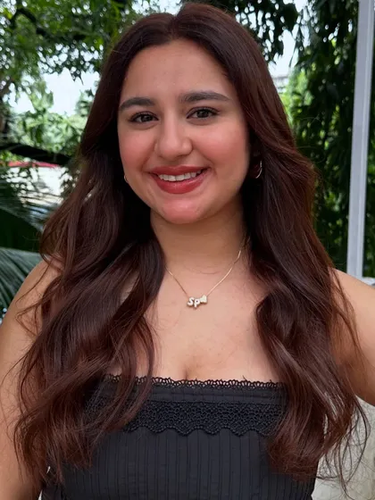 A smiling client, happy with her birthday hair.