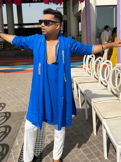 Full look of my royal blue Haldi outfit. I believe in looking the part, and my attire is always chosen to enhance the visual spectacle of your wedding events.