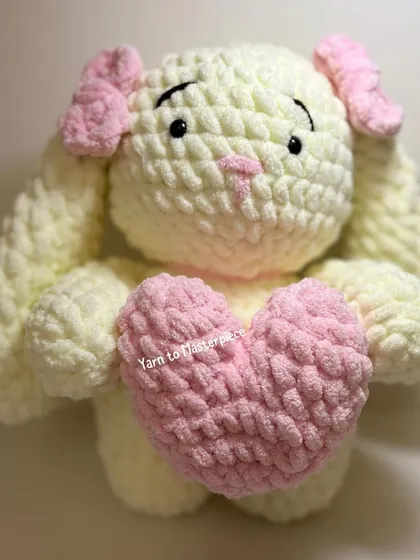 My large plushie bunny, shown here holding a soft pink heart, is made with extra-fluffy yarn for a super soft and squishy feel.