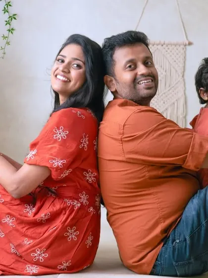 A fun back-to-back pose for the whole family. This playful arrangement makes for a unique and memorable family portrait.