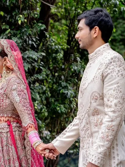 The couple walking hand-in-hand, a beautiful moment captured.