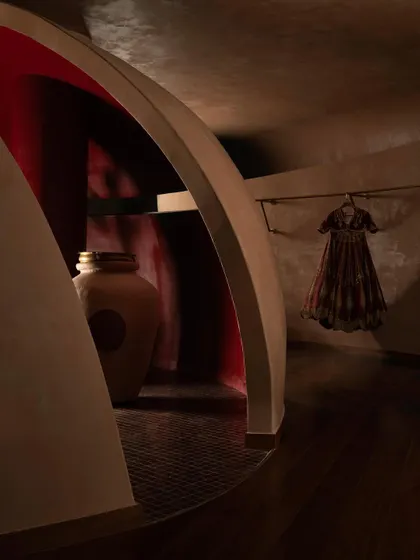 An arched threshold at the House of Masaba reveals a glimpse of a vibrant red interior, a nod to bridal sindoor. This interplay of color and form adds layers of meaning and discovery to the retail experience.