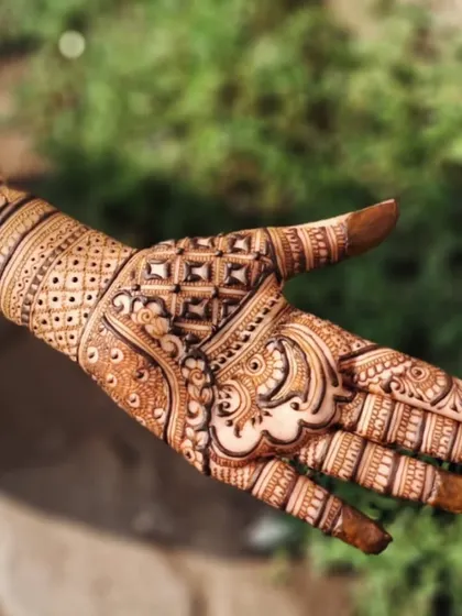 A close-up of the full-hand party design, showing the combination of geometric and paisley patterns.