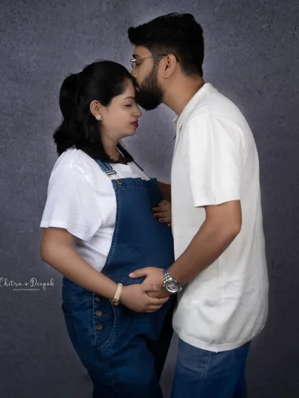 A tender kiss on the forehead. This simple gesture is full of love and captures the protective bond between the couple.