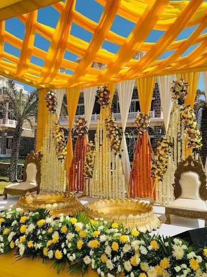 A stunning couple's Haldi ceremony setup designed for an outdoor venue. We used a vibrant yellow and white color palette with extensive floral decorations, including marigolds and tuberoses, creating a traditional and photogenic space for the ritual.