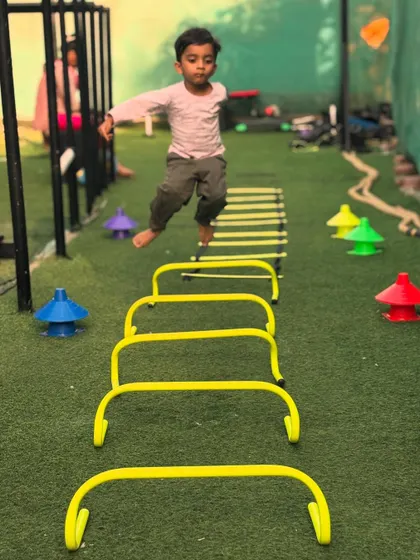 Even our 3-year-old members are strong. Here, a young boy works on his agility and coordination with ladder and hurdle drills.