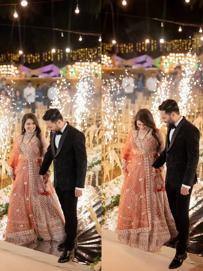 The couple descending the stairs at their reception venue, surrounded by the magical glow of sparklers.
