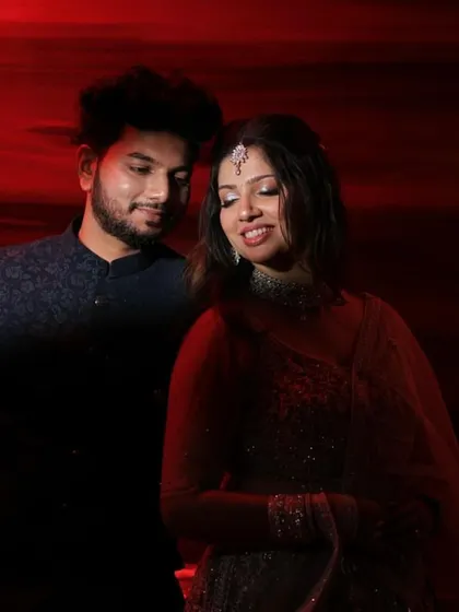 A dramatic and romantic shot of the couple. The soft glam makeup on the bride looks stunning in this moody lighting.
