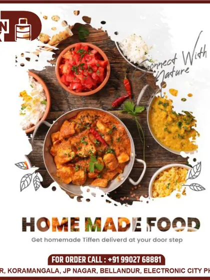I focus on using fresh, natural ingredients in my cooking. This overhead shot displays a variety of homemade dishes, from rich curries to simple salads, all ready to be packed and delivered.