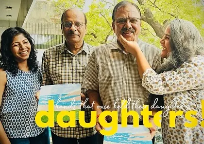 Hands that once held their daughters now hold a paintbrush. A heartwarming photo of fathers and daughters painting together.