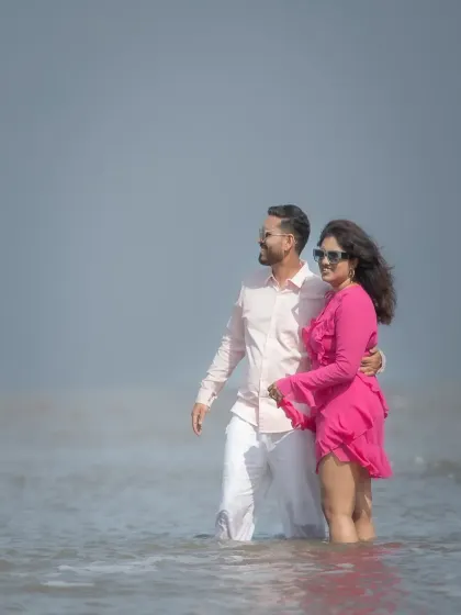 A romantic moment in the water during a pre-wedding beach session. The soft, hazy light gives this portrait a dreamy and ethereal quality.