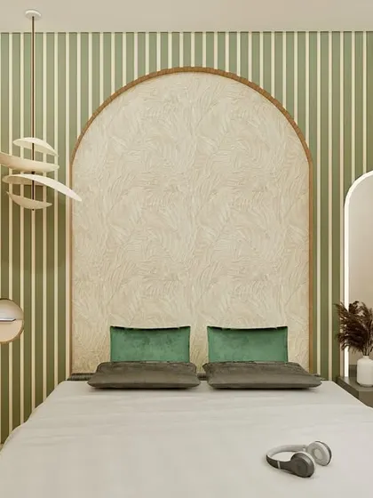 This bedroom is a sanctuary of calm, blending muted greens with natural wood and cane textures. The arched accent wall behind the bed creates a soft, inviting focal point, while the perforated wardrobe doors and layered lighting add depth and warmth. It’s a minimalist design that is rich in detail, perfect for unwinding after a long day.