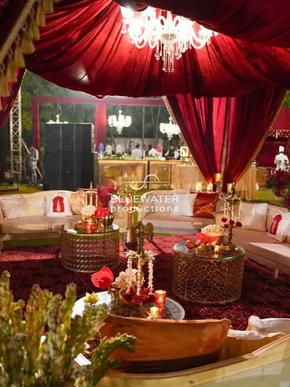 The combination of rich red fabrics, ornate furniture, and warm lighting creates a lounge space that feels both comfortable and incredibly grand.