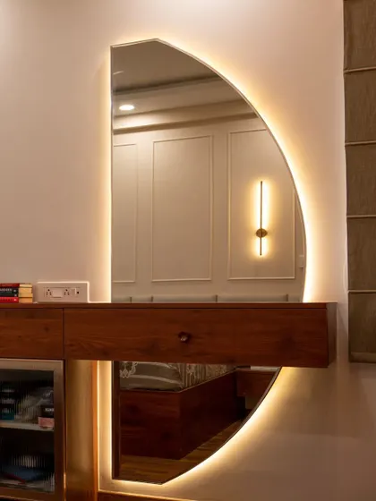 A beautifully backlit vanity mirror in a semi-circle shape, providing perfect, even lighting for getting ready.