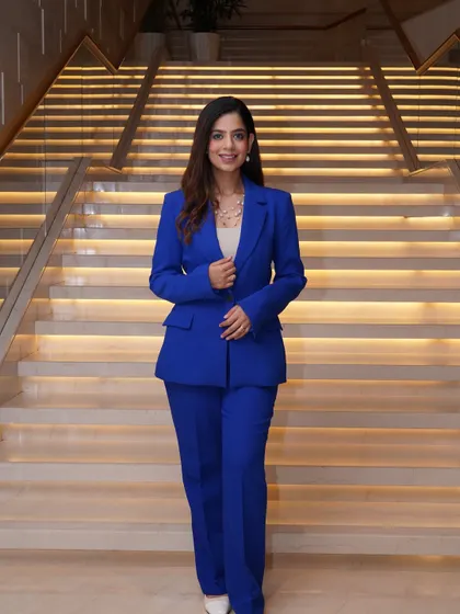 A full-length view of my blue power suit against a beautifully lit staircase.