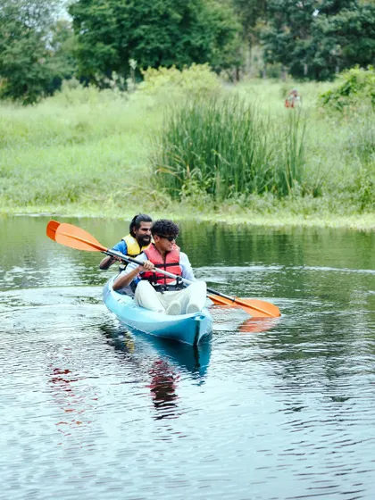 Two guests paddle in sync, exploring the gentle currents of the river. Kayaking is a wonderful activity for couples and friends to share a peaceful moment.