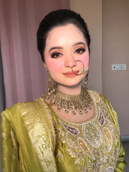 A beautiful portrait of my Pahadi-inspired look, featuring a traditional nath and soft, rosy makeup.