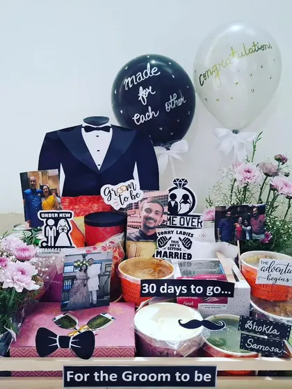 This hamper for a groom-to-be features a delicious platter of popular Indian street food. It includes Pani Puri, Dhokla, Samosa, and Pav Bhaji to pamper him before the wedding.