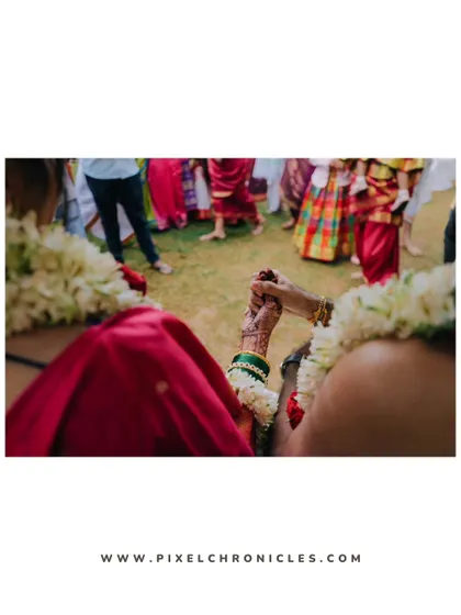 An over-the-shoulder shot of the couple holding hands, focusing on the connection between them.